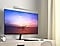 A monitor in a bedroom has a brightness level bar superimposed above it. As the room gets brighter, the brightness bar's indicator moves left and the monitor brightens. As the room gets dimmer, the bar's indicator moves right and the monitor dims.