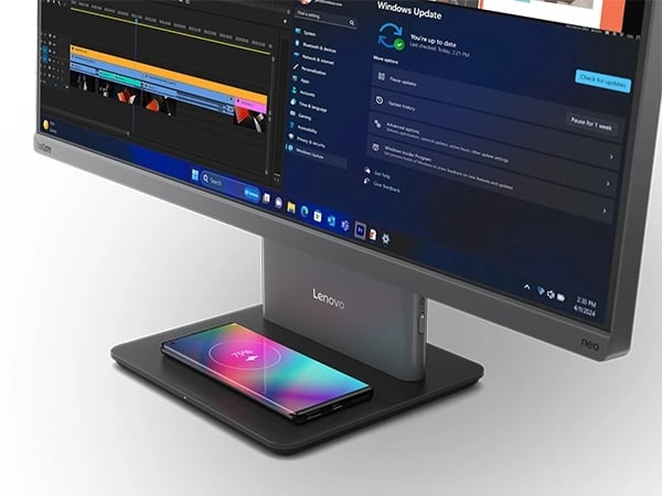Lenovo ThinkCentre Neo 50a G5 27&Prime;all-in-one desktop PC -- front-right view with a  closeup, showing the base wirelessly charging a mobile phone.