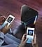2 people are pairing their phones via Sound Tower's Bluetooth Multi Connection function. A Sound Tower is on display.