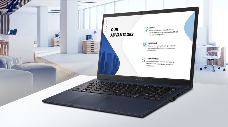 Vue lat&eacute;rale de l'ExpertBook B1 sur un tableau blanc dans un bureau avec des graphiques lin&eacute;aires et des graphiques &agrave; barres &agrave; l'&eacute;cran.  