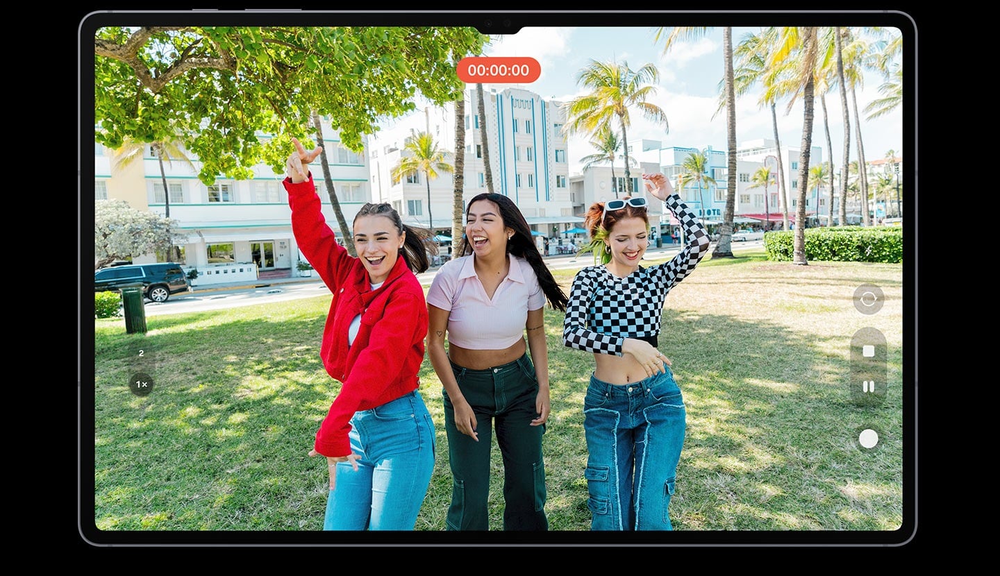 L&rsquo;&eacute;cran de la tablette affiche un enregistrement vid&eacute;o de trois femmes posant avec joie. Des reflets et &eacute;blouissements apparaissent &agrave; l&rsquo;&eacute;cran, ce qui rend l&rsquo;image affich&eacute;e floue.