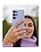 A person holds a Galaxy S25 Ultra installed with the Silicone Case in Light Blue.