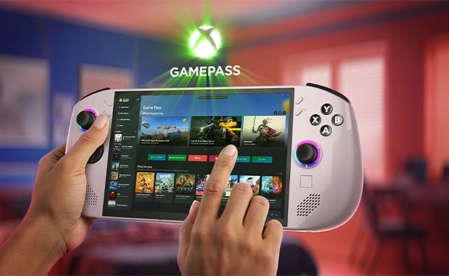 Hands holding Lenovo Legion Go S Gen 1 (8") gaming handheld displaying Xbox Game Pass library in a cozy room.