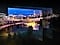 A city lit up by bright lights is on display. The colors and lights are vivid as OLED lights portray through the QD screen.