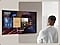 A man looks at a blank TV screen. The screen activates to display Daily Board, which shuffles through widgets for Weather, Memo, Music, Home Stats, Samsung TV Plus and Tips. It also displays the time and date, along with a voice prompt to play relaxing music.