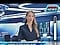 TV anchor presenting the news. Icon for brightness shows logo and taskbar reducing in brightness.