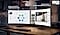 There are two monitors, and the left one flickers and emits blue light since the Eye Saver Mode is off. The right one is less flickering and does not emit blue light as its Eye Saver Mode is on. Above them, there is a TUV certification logo.