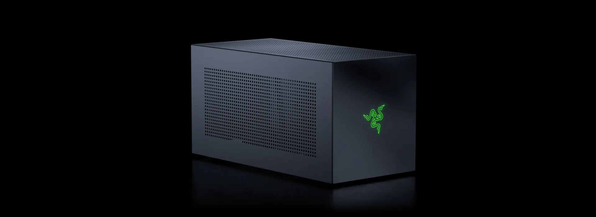A sleek black Razer gaming PC with a mesh side panel, small green Razer logo on front, set against a dark background.