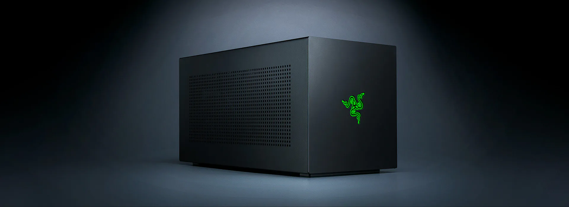 A sleek black Razer gaming PC with a glowing green Razer logo, set against a dark background.