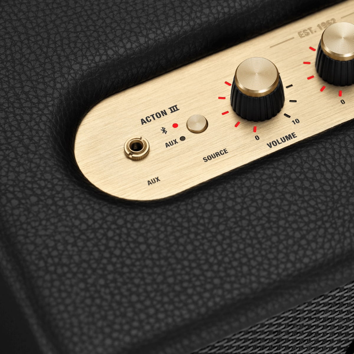 A close-up of a black Marshall Acton III speaker with golden knobs seen from above.