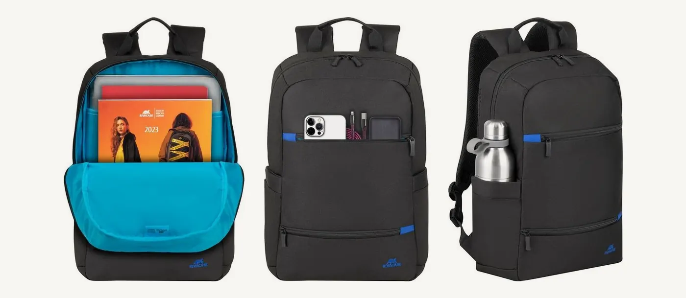 Sac Rivacase 8265 ouvert sur sa doublure bleue avec un ordinateur et une revue, poches avant garnies d'un téléphone, et bouteille dans la poche latérale
