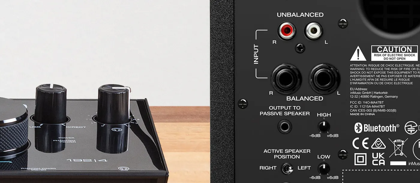 Face arrière de l'enceinte active BX3 BT : entrées RCA, deux jacks symétriques, sortie vers l'enceinte passive, correcteurs High et Low, sélecteur de position, à côté d'une interface audio