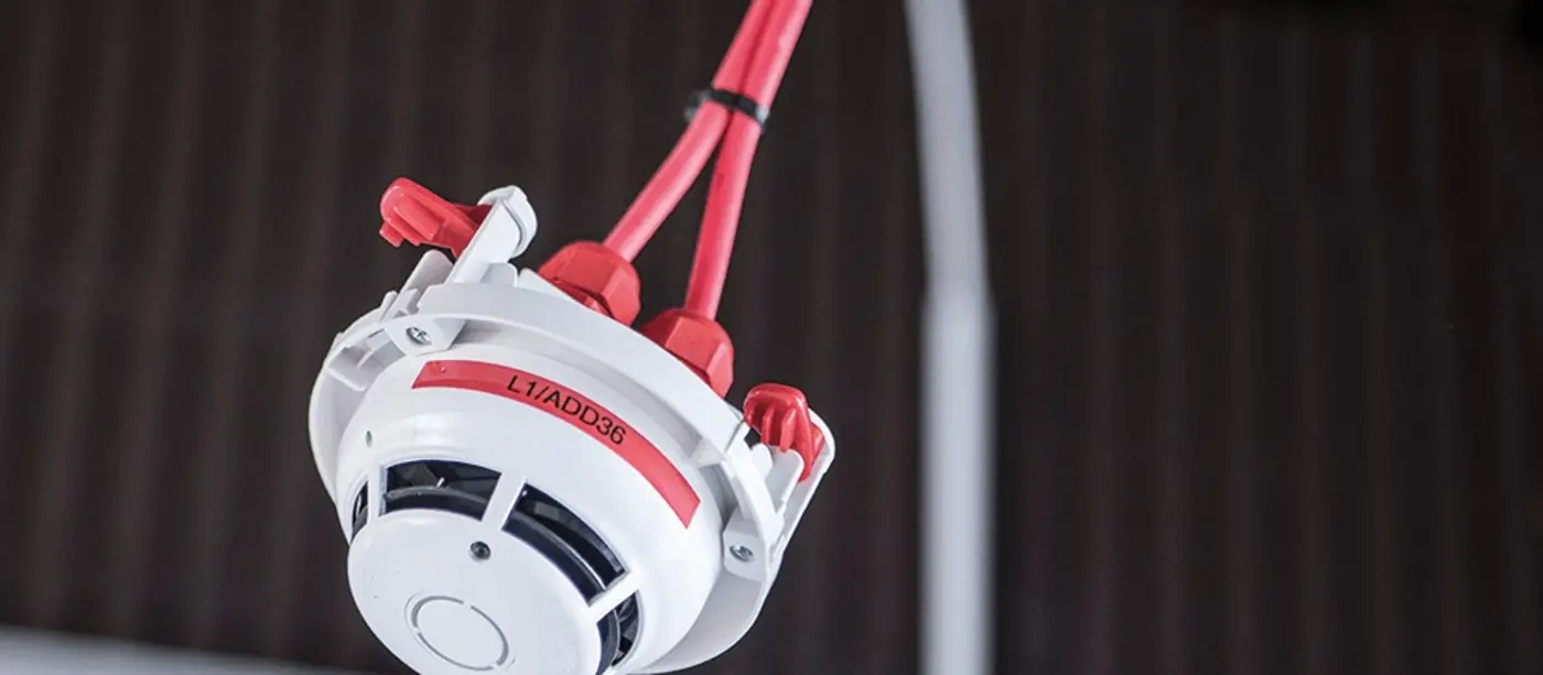 D&eacute;tecteur de fum&eacute;e au plafond portant une &eacute;tiquette lamin&eacute;e imprim&eacute;e L1/ADD36